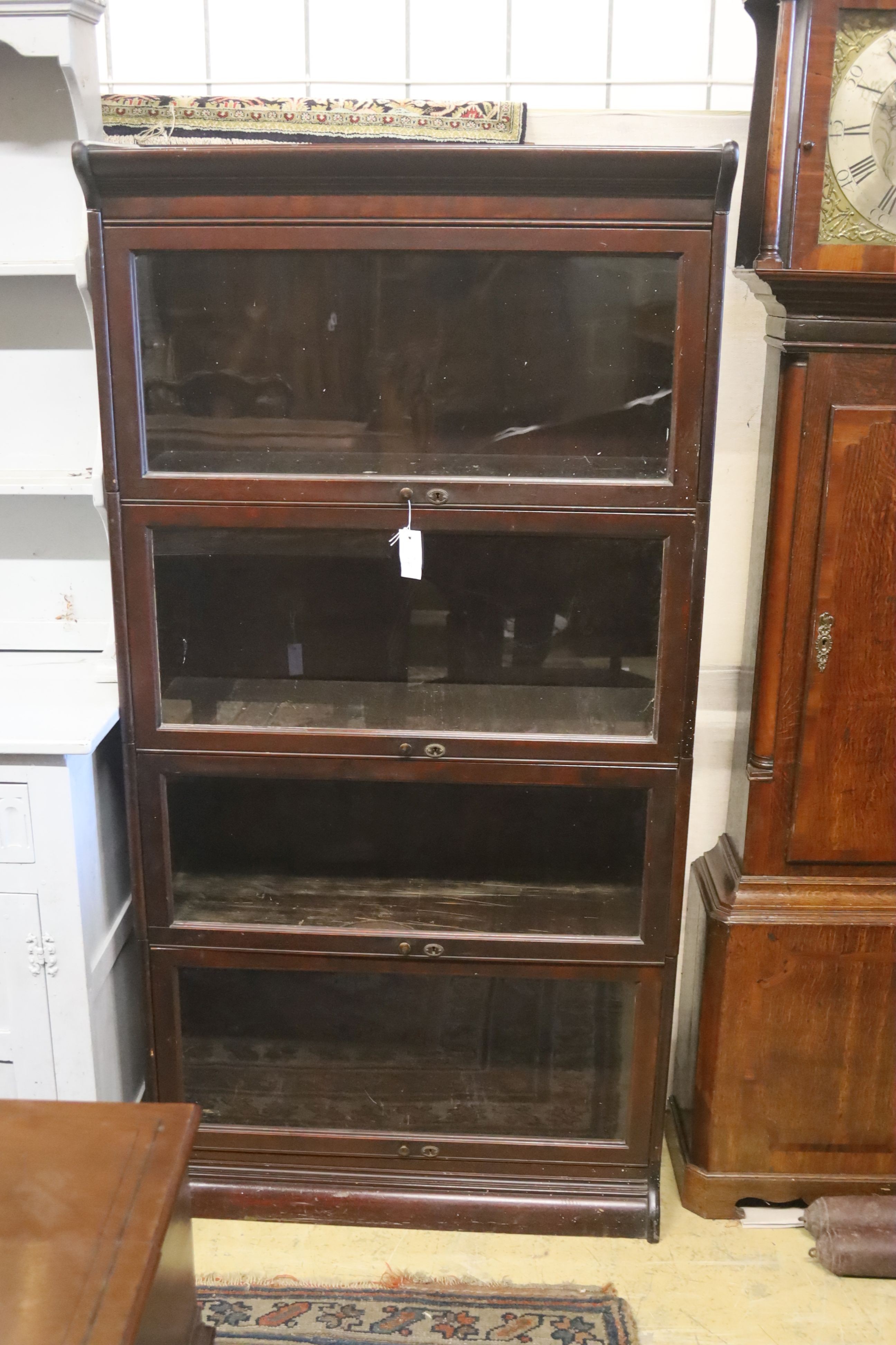 A Globe Wernicke style mahogany four section bookcase. W-86cm, D-36cm, H-172cm.